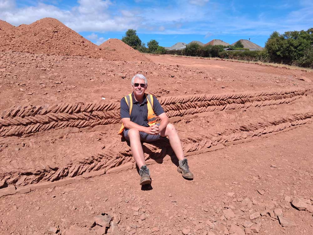 Bill Horner, Devon County Archaeologist & Historic Environment Manager sat at the Preston Down Road, Paignton in 2026